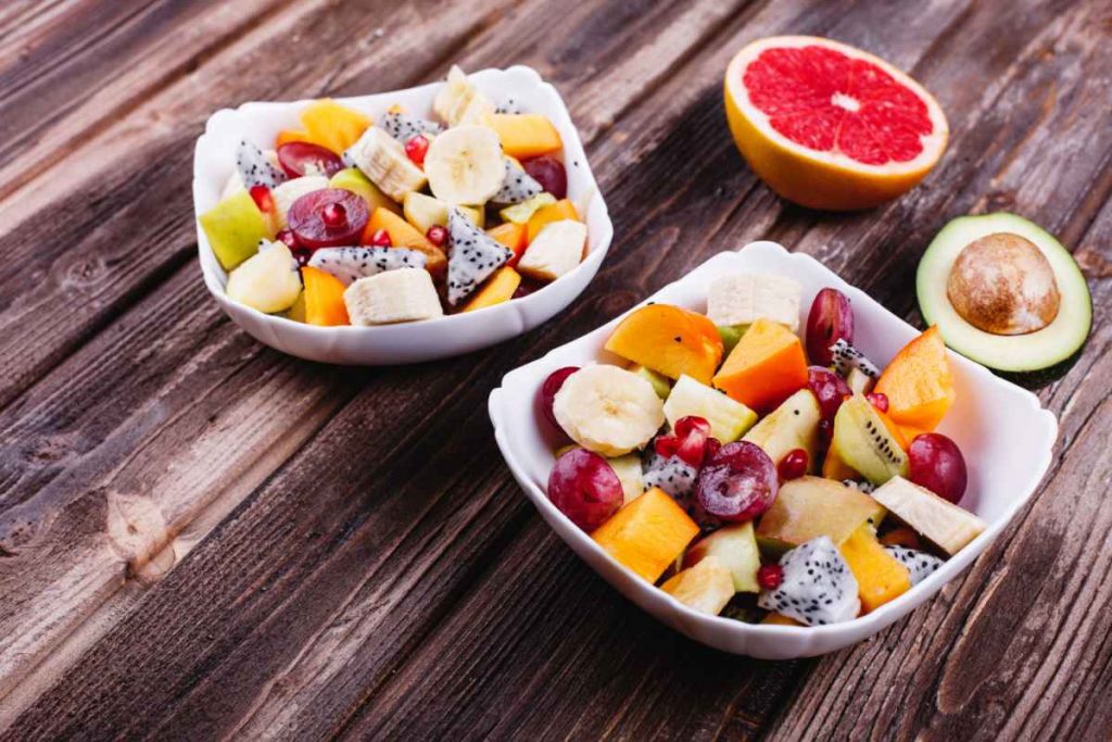 Fresh and Tasty Fruit Bowls on wooden table