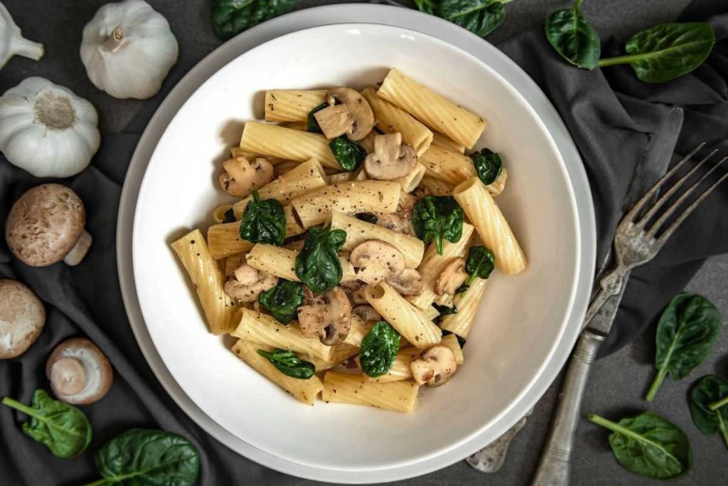 Pasta in a round Bowl with green leaves